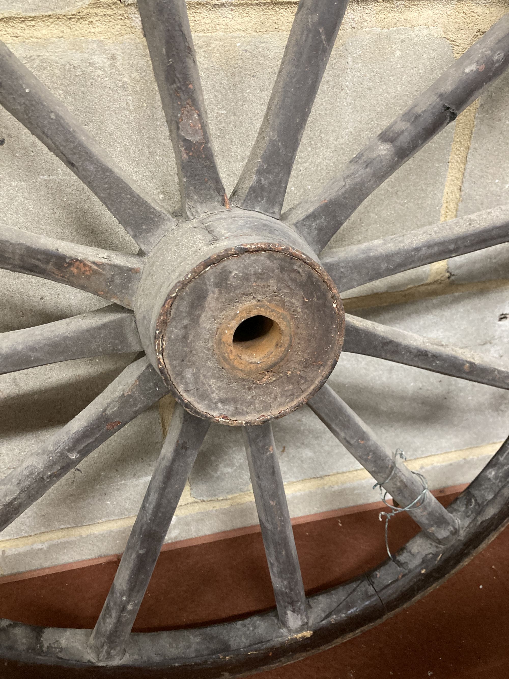 A pair of Victorian iron mounted spoked cart wheels, 70cm diameter